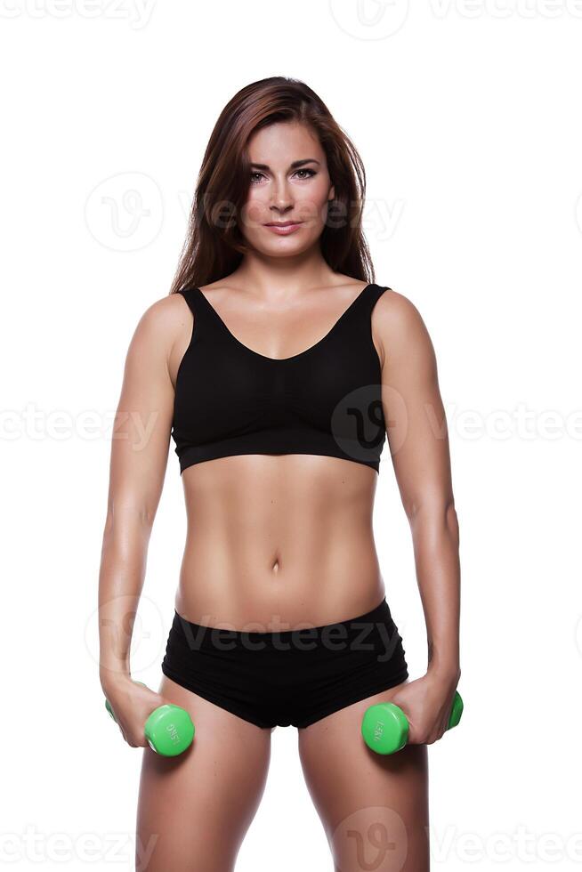 Fitness girl with dumbbells on a white background photo