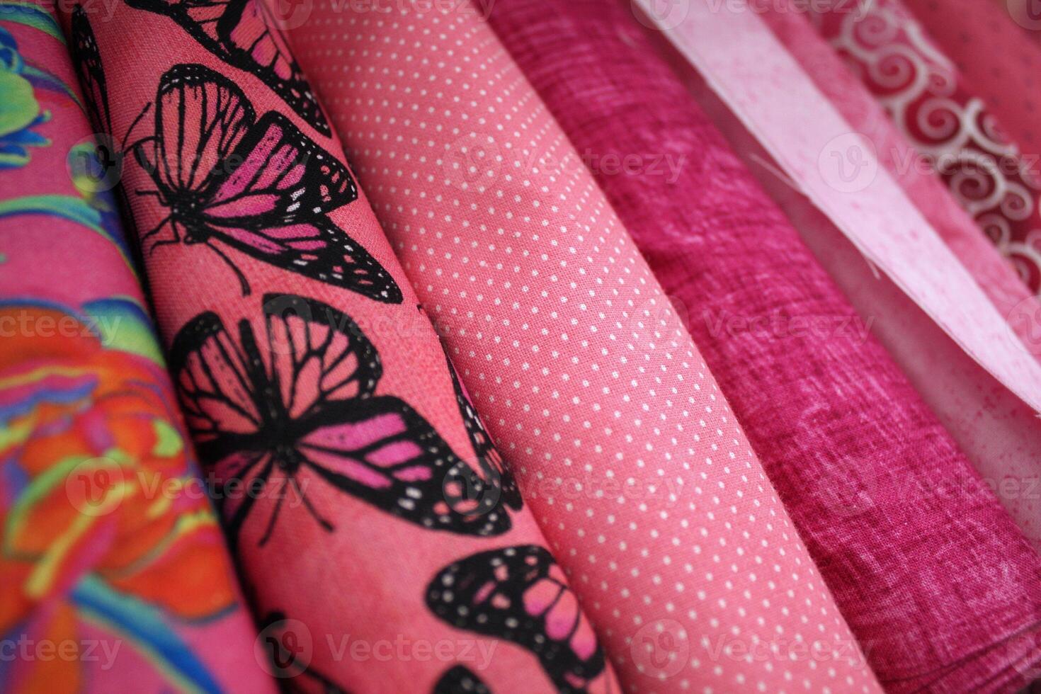 Vibrantly Colored Bolts of Pink Printed Fabric photo
