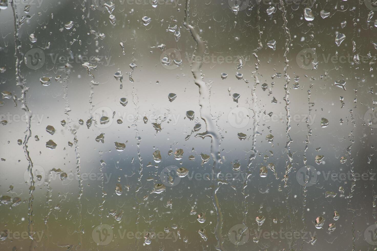 Window glass surface covered by water droplets photo