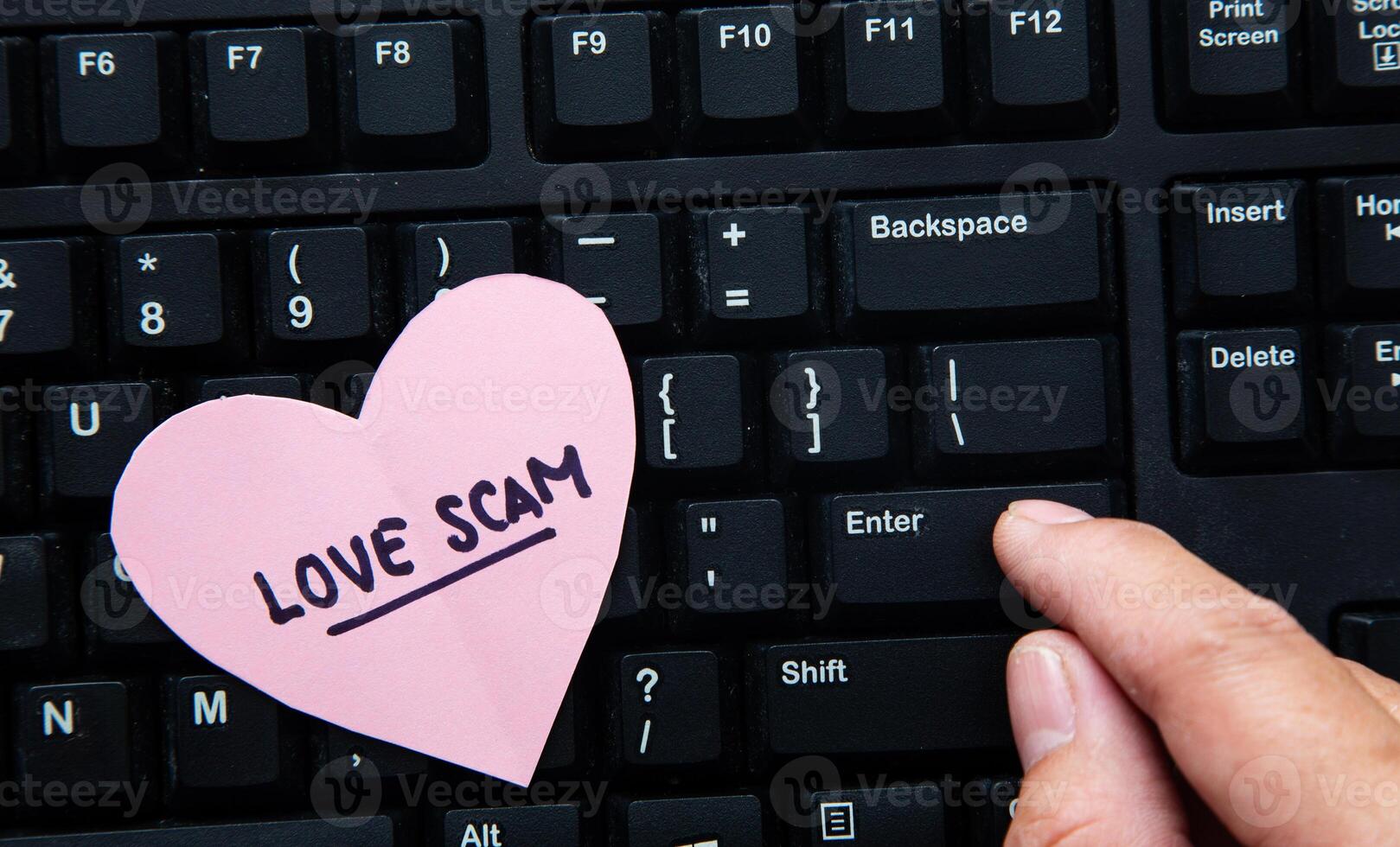 Hand communicating with scammer via computer. photo
