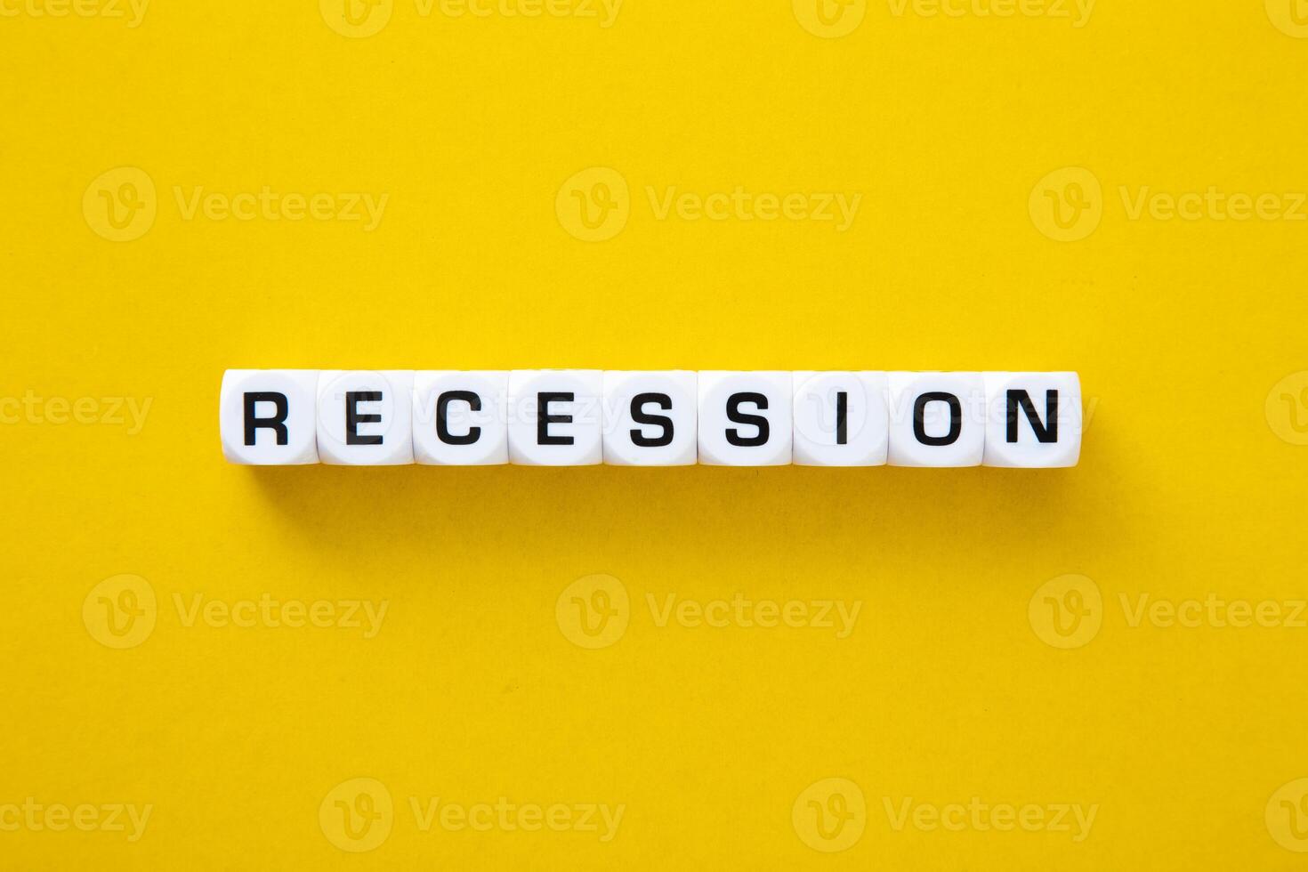 Recessios word on yellow background. Downturn Economy Concept photo