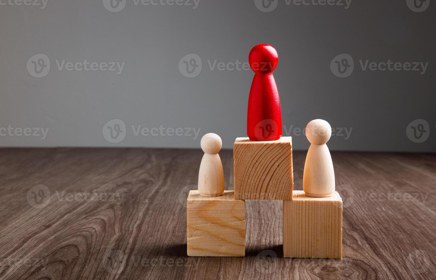 woodenl figures standing on wooden podium, business team competition concept. photo