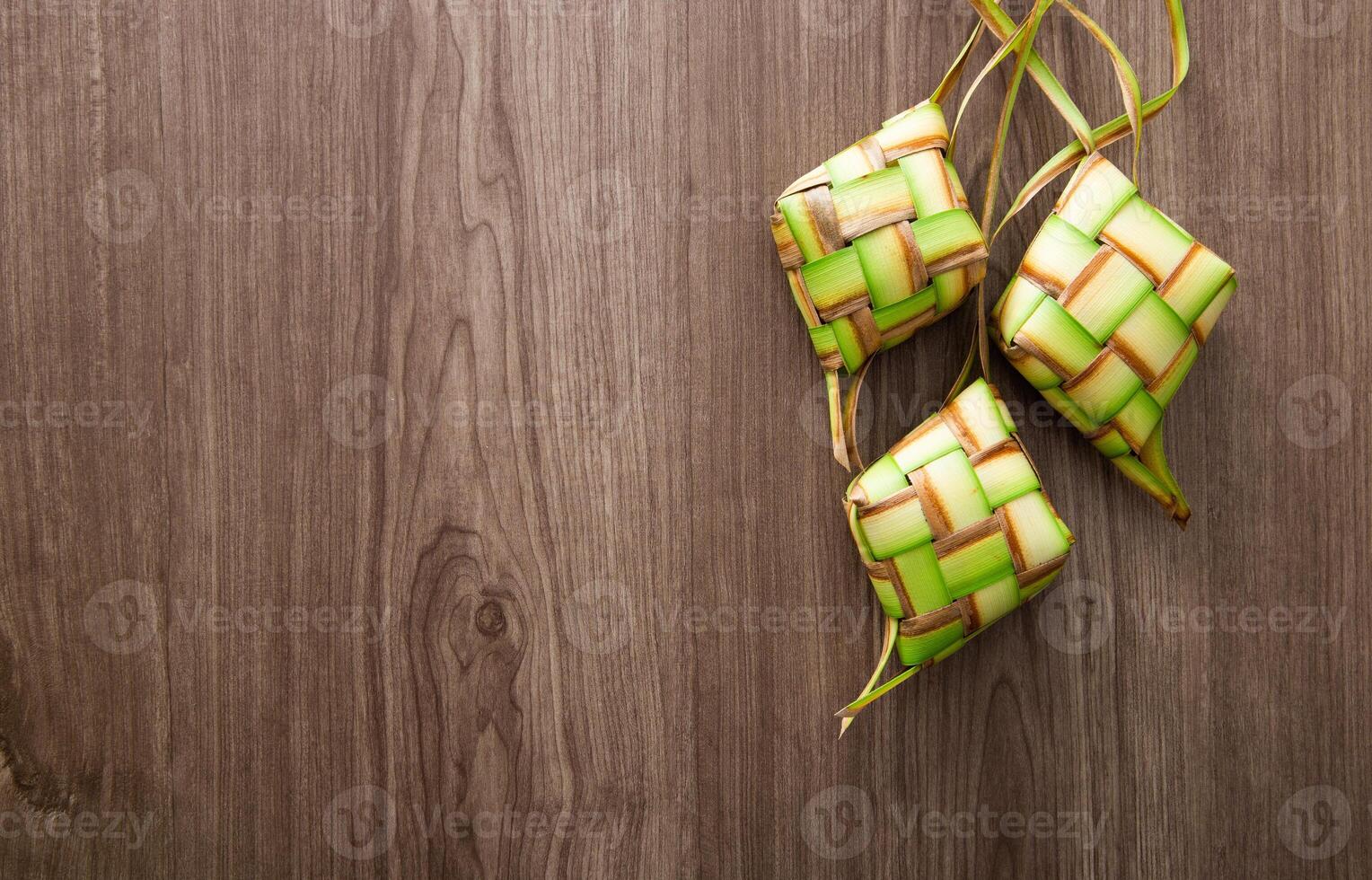 Kelongsong Ketupat decoration on wooden table. photo