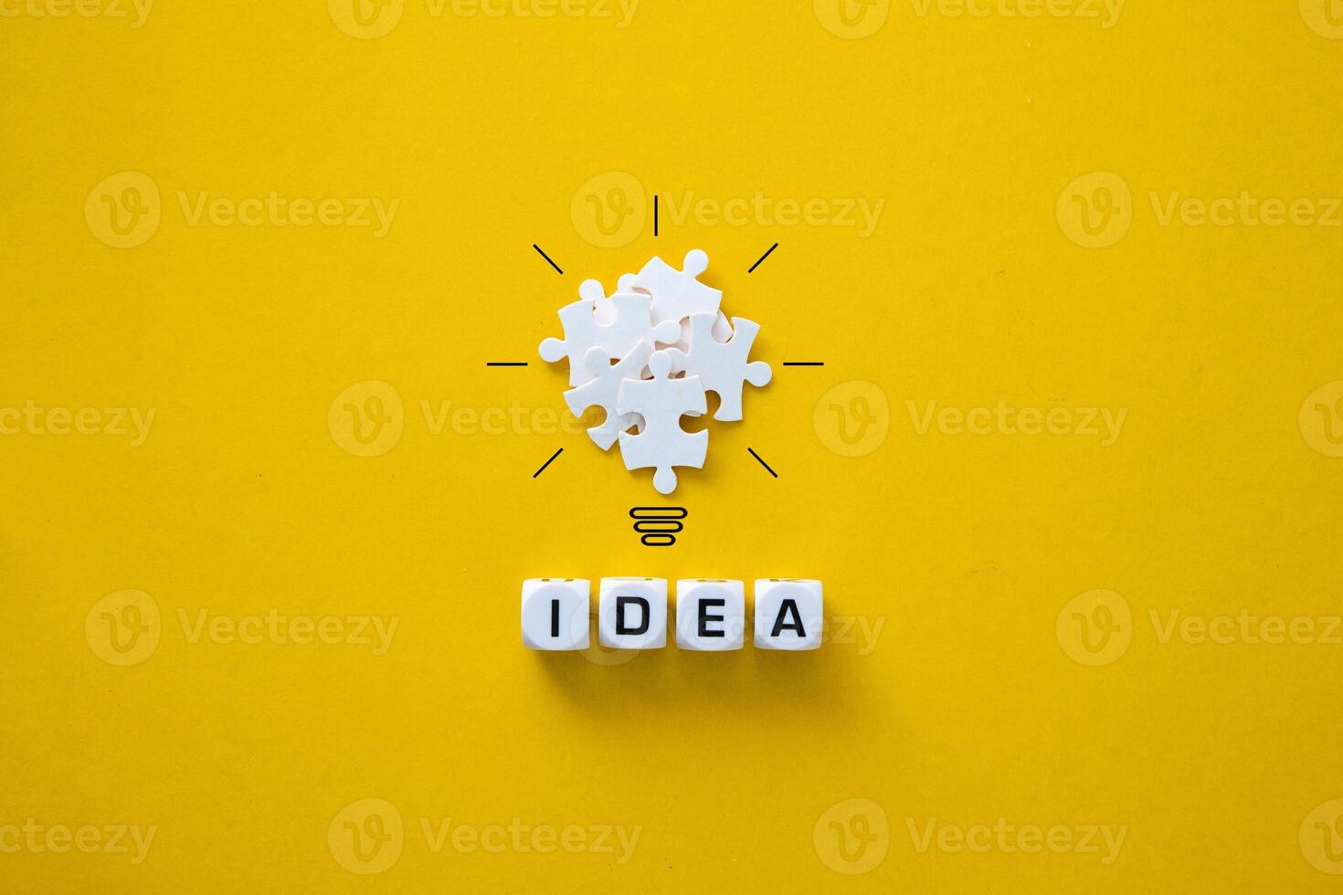 Light bulb from puzzles on yellow background. photo