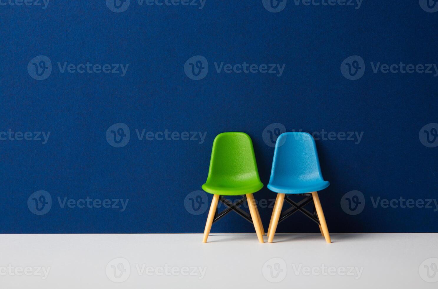 Two chairs against a blue wall. Business Concept photo