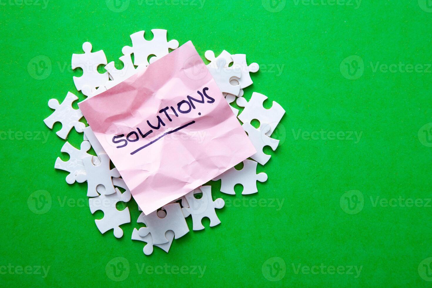 Solutions word on pink paper. photo