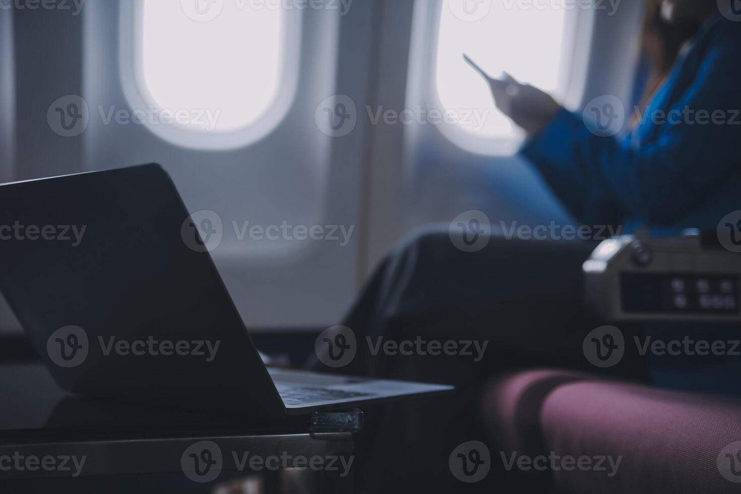 Using mobile and laptop, Thoughtful asian people female person onboard, airplane window, perfectly capture the anticipation and excitement of holiday travel. chinese, japanese people. photo