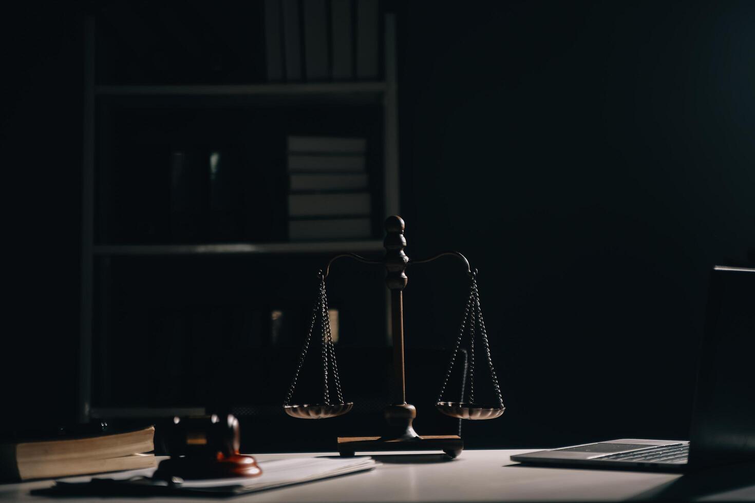 Business and lawyers discussing contract papers with brass scale on desk in office. Law, legal services, advice, justice and law concept picture with film grain effect photo