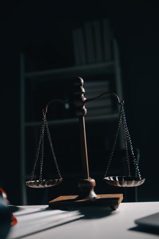 Business and lawyers discussing contract papers with brass scale on desk in office. Law, legal services, advice, justice and law concept picture with film grain effect photo