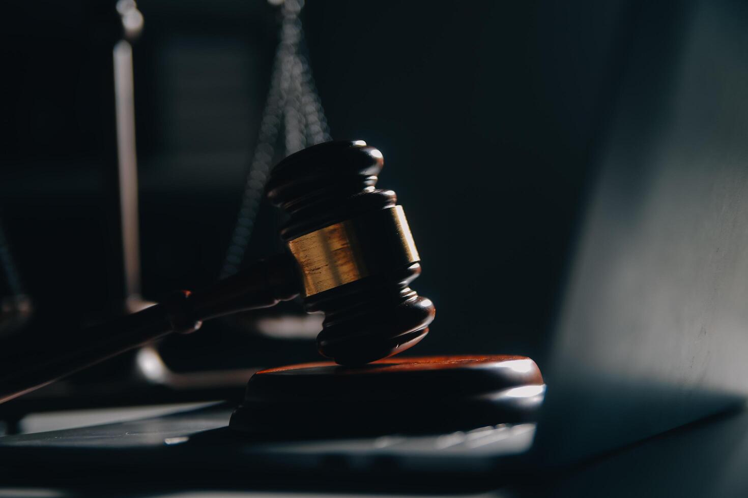 Business and lawyers discussing contract papers with brass scale on desk in office. Law, legal services, advice, justice and law concept picture with film grain effect photo
