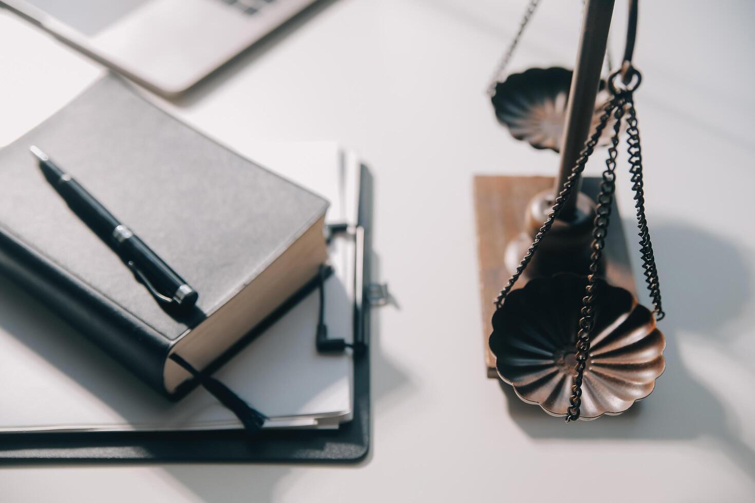 Business and lawyers discussing contract papers with brass scale on desk in office. Law, legal services, advice, justice and law concept picture with film grain effect photo