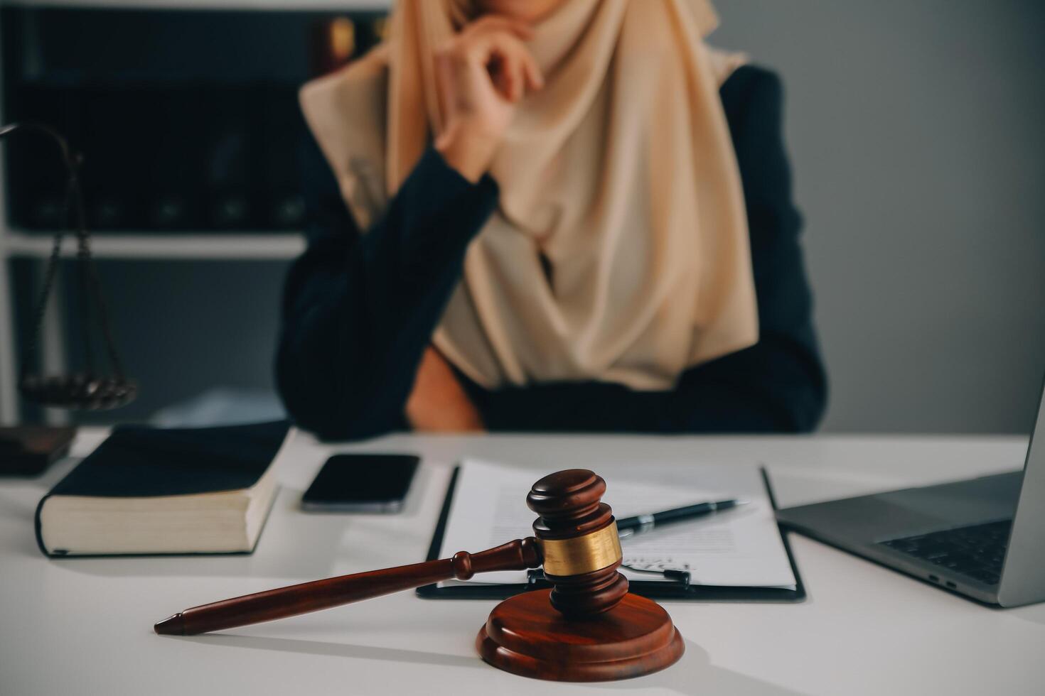 Business and lawyers discussing contract papers with brass scale on desk in office. Law, legal services, advice, justice and law concept picture with film grain effect photo