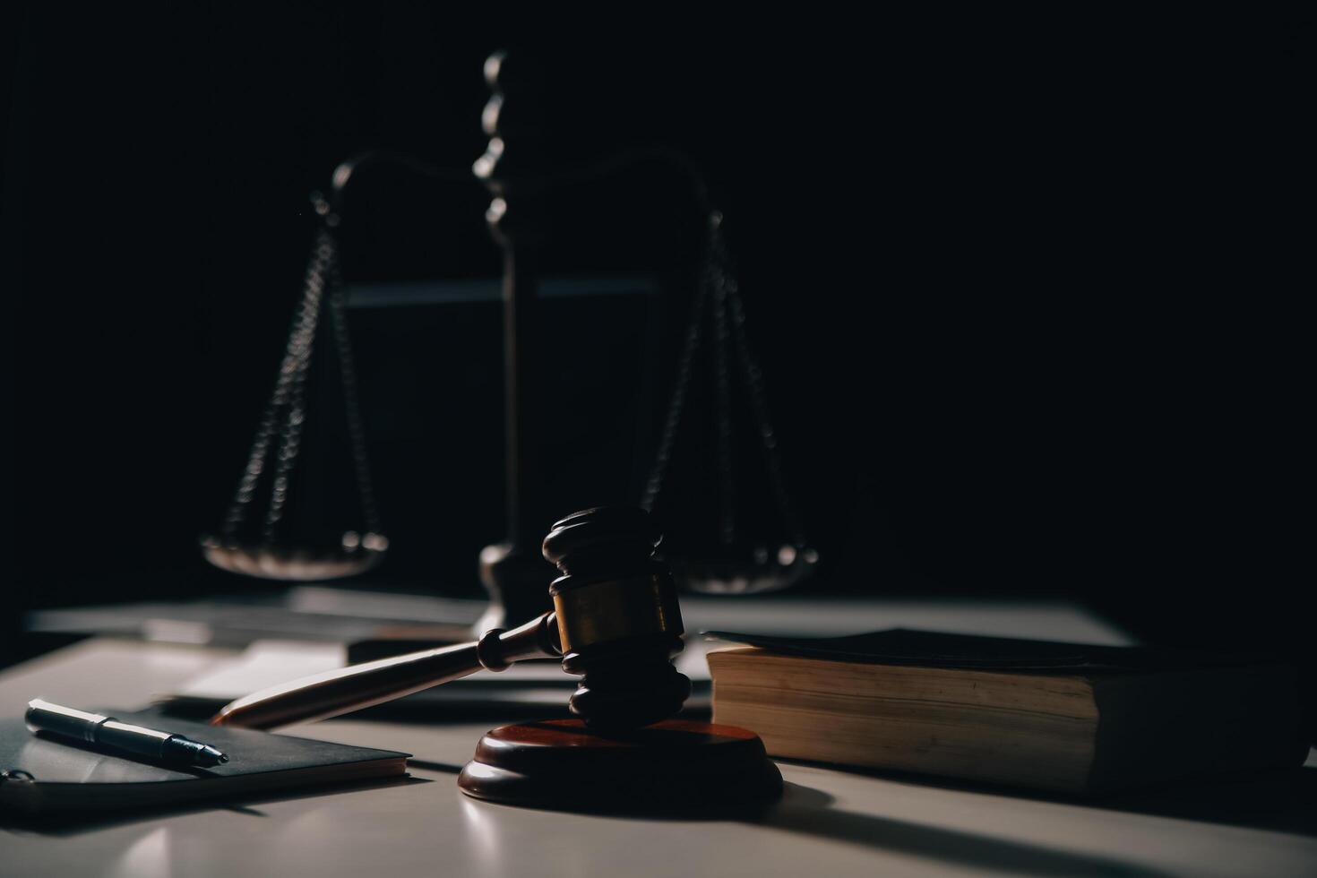 Business and lawyers discussing contract papers with brass scale on desk in office. Law, legal services, advice, justice and law concept picture with film grain effect photo