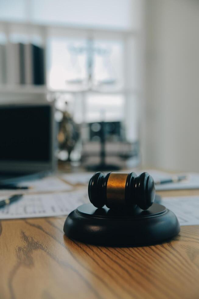 Consultation and conference of Male lawyers and professional businesswoman working and discussion having at law firm in office. Concepts of law, Judge gavel with scales of justice. photo