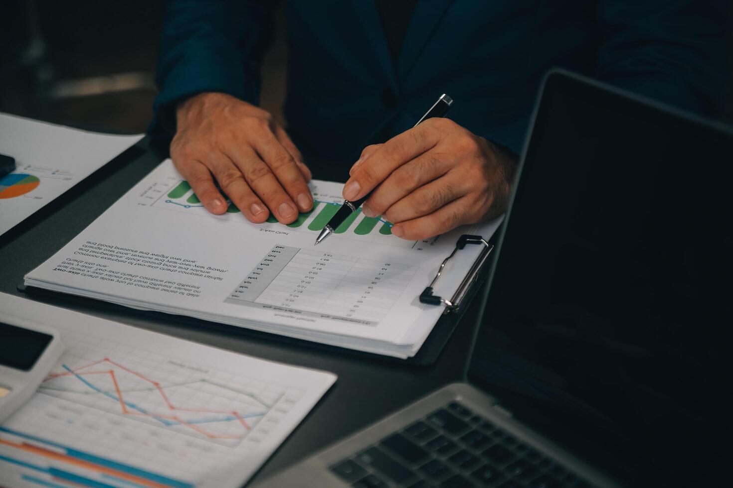 Financial Business team present. Business man hands hold documents with financial statistic stock photo, discussion, and analysis report data the charts and graphs. Finance Financial concept photo