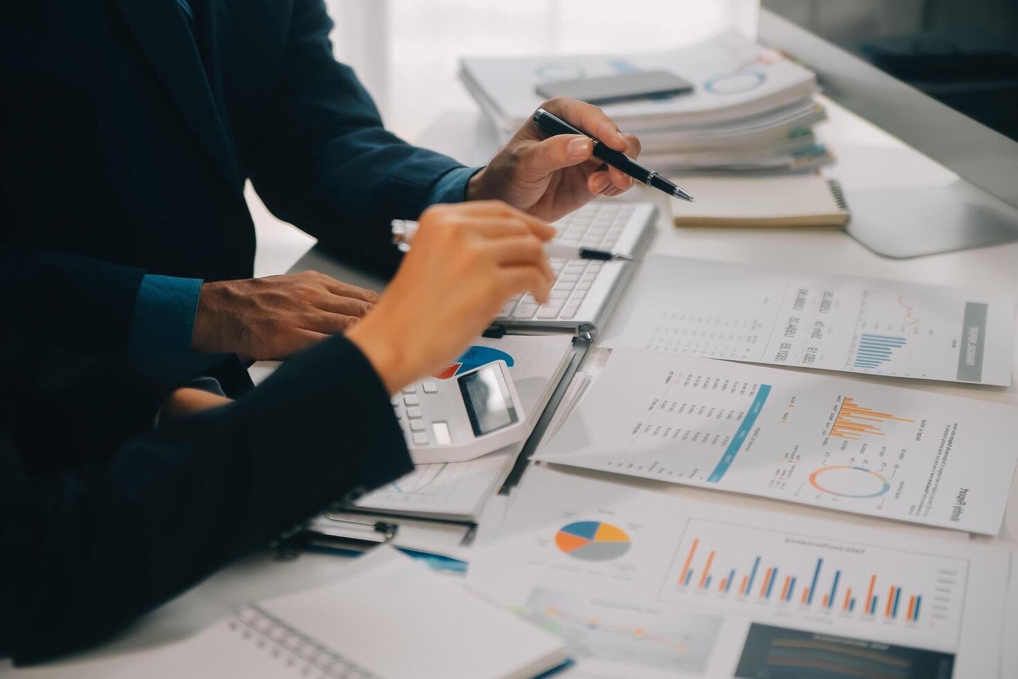 Financial analysts analyze business financial reports on a digital tablet planning investment project during a discussion at a meeting of corporate showing the results of their successful teamwork. photo