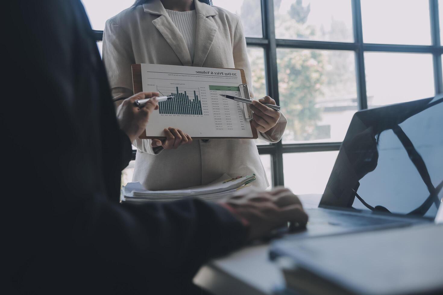 Financial analysts analyze business financial reports on a digital tablet planning investment project during a discussion at a meeting of corporate showing the results of their successful teamwork. photo