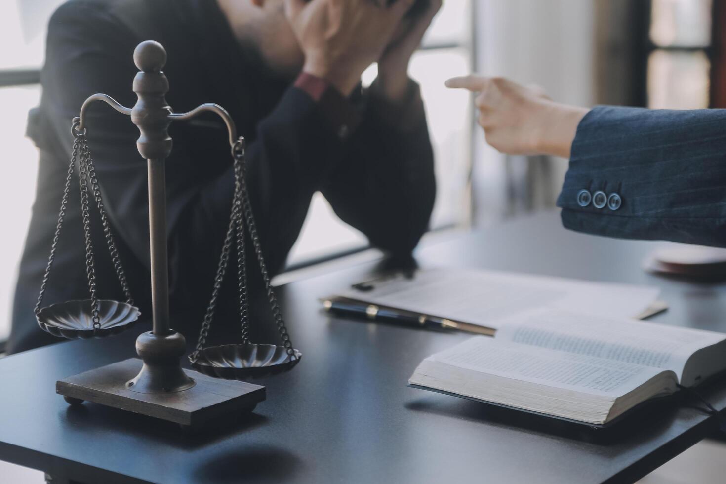 Business and lawyers discussing contract papers with brass scale on desk in office. Law, legal services, advice, justice and law concept picture with film grain effect photo