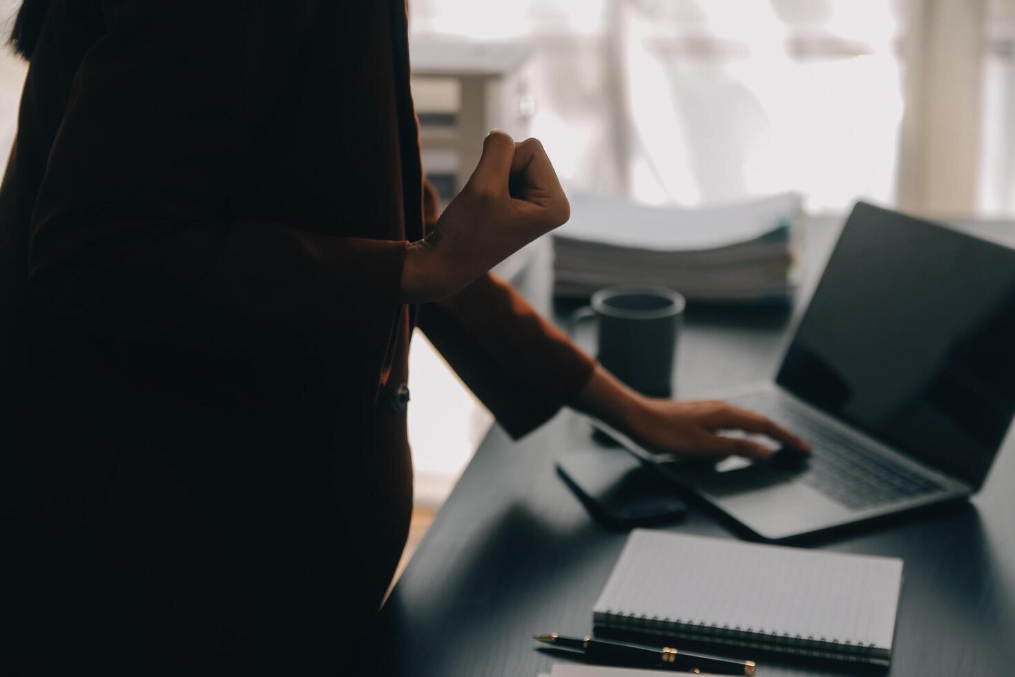 Asian Business woman using calculator and laptop for doing math finance on an office desk, tax, report, accounting, statistics, and analytical research concept photo