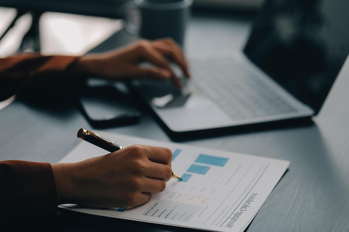 Asian Business woman using calculator and laptop for doing math finance on an office desk, tax, report, accounting, statistics, and analytical research concept photo