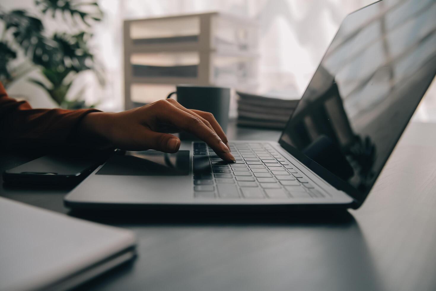 Asian Business woman using calculator and laptop for doing math finance on an office desk, tax, report, accounting, statistics, and analytical research concept photo