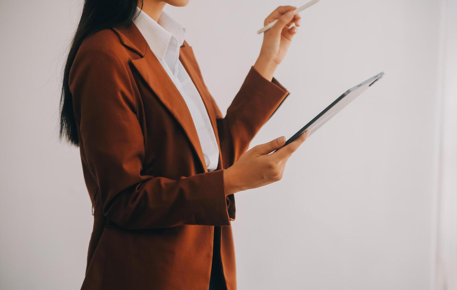 Asian Business woman using calculator and laptop for doing math finance on an office desk, tax, report, accounting, statistics, and analytical research concept photo