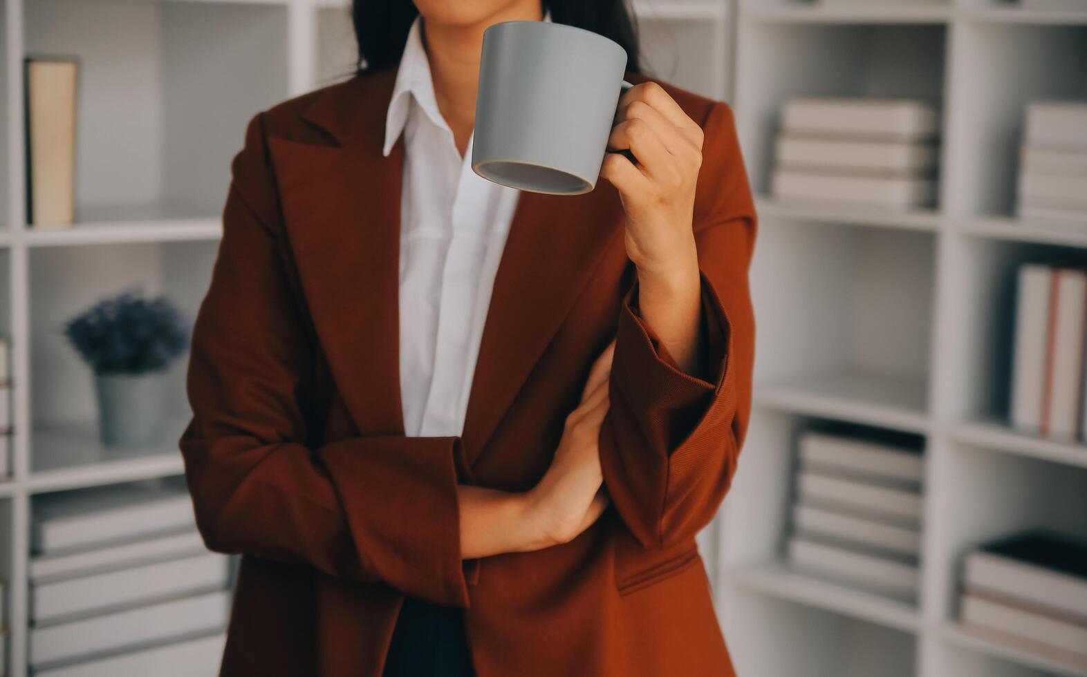 Asian Business woman using calculator and laptop for doing math finance on an office desk, tax, report, accounting, statistics, and analytical research concept photo