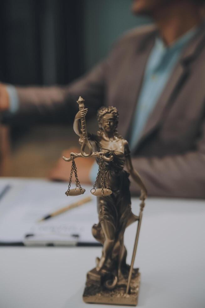 Business and lawyers discussing contract papers with brass scale on desk in office. Law, legal services, advice, justice and law concept picture with film grain effect photo