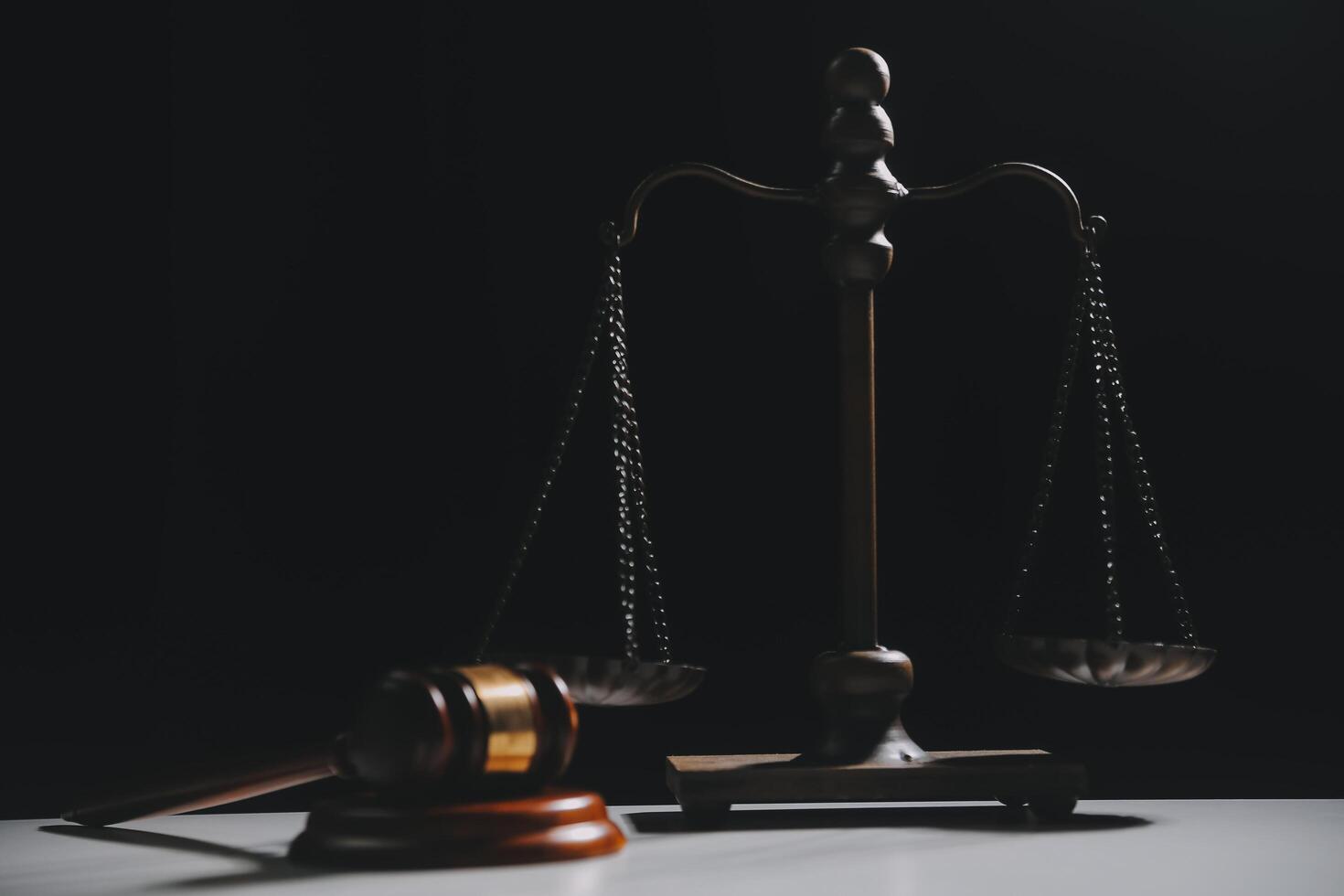 image of judge's hammer, scales lady of justice, law book, laptop computer and contract documents with pen concept of law and justice. photo