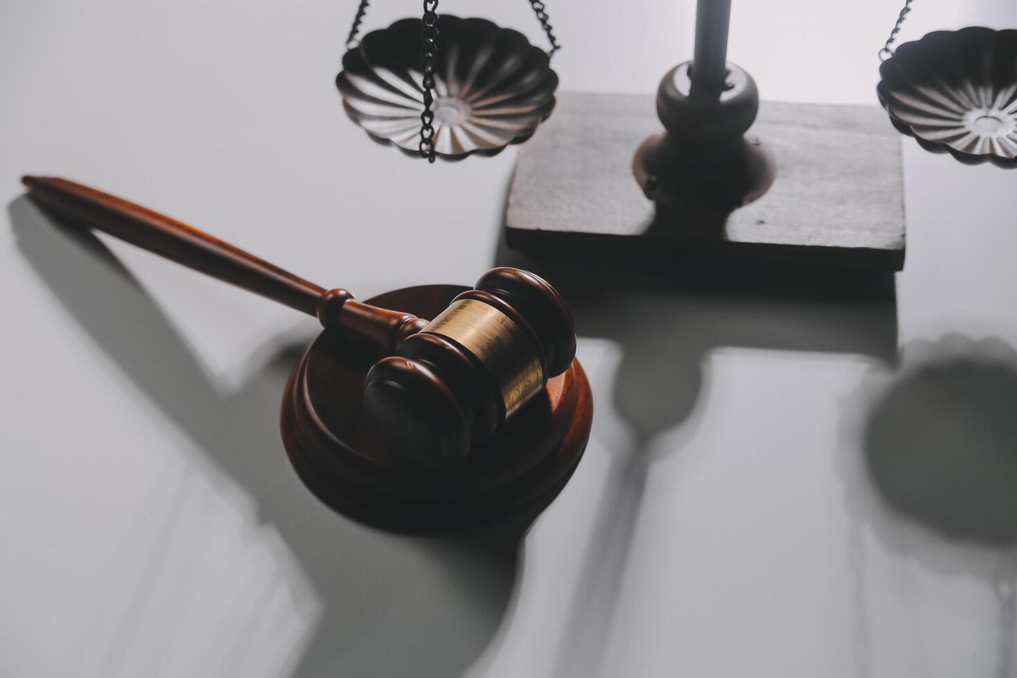 image of judge's hammer, scales lady of justice, law book, laptop computer and contract documents with pen concept of law and justice. photo