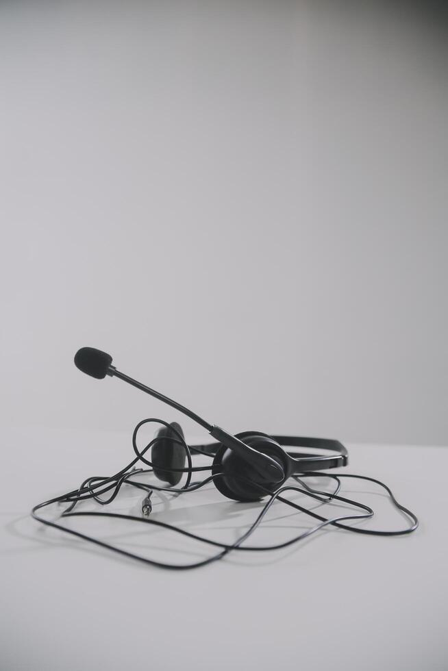 Communication support, call center and customer service help desk. VOIP headset on telephone keyboard. photo