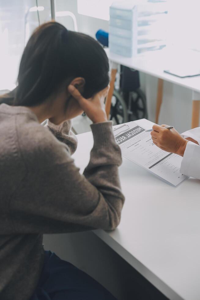 Close up serious doctor wearing medical face mask consulting mature woman patient at appointment in office, physician explaining treatment, giving recommendations, elderly generation healthcare photo