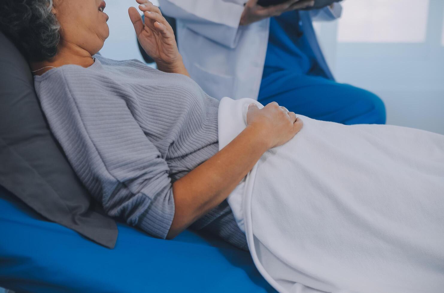Female doctor administers specialized medical treatment to a patient in a hospital room. The procedure includes fluid therapy and injections to support the patient's health diagnosis and recovery. photo