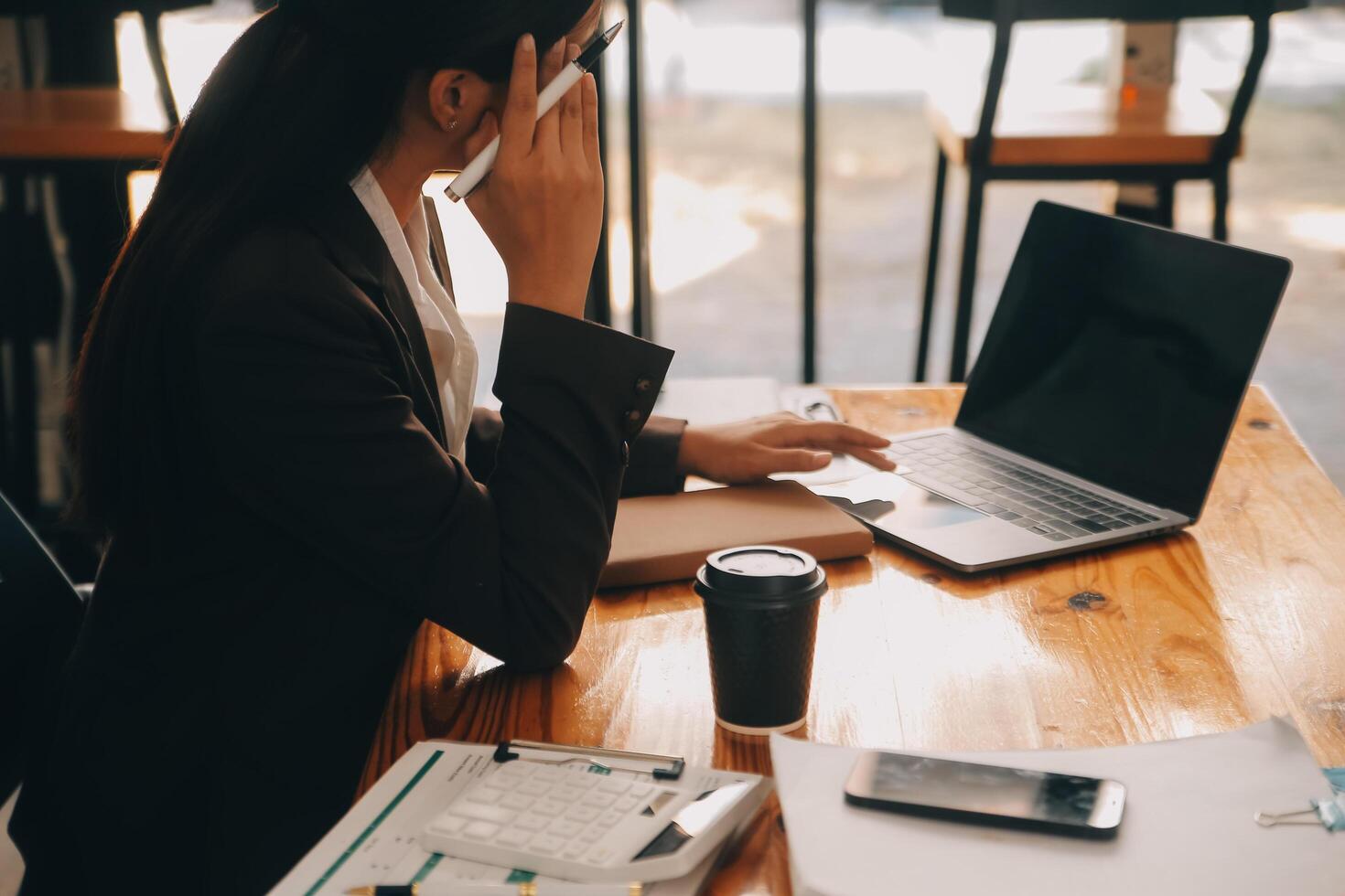 Asian women are stressed while working on laptop, Tired asian businesswoman with headache at office, feeling sick at work, copy space photo