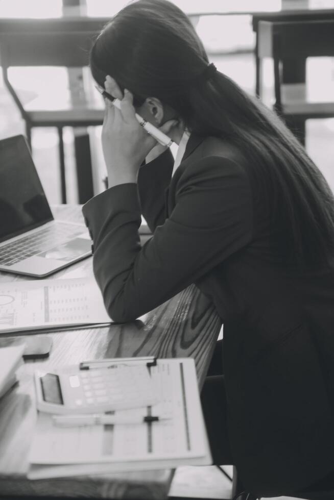 Asian women are stressed while working on laptop, Tired asian businesswoman with headache at office, feeling sick at work, copy space photo