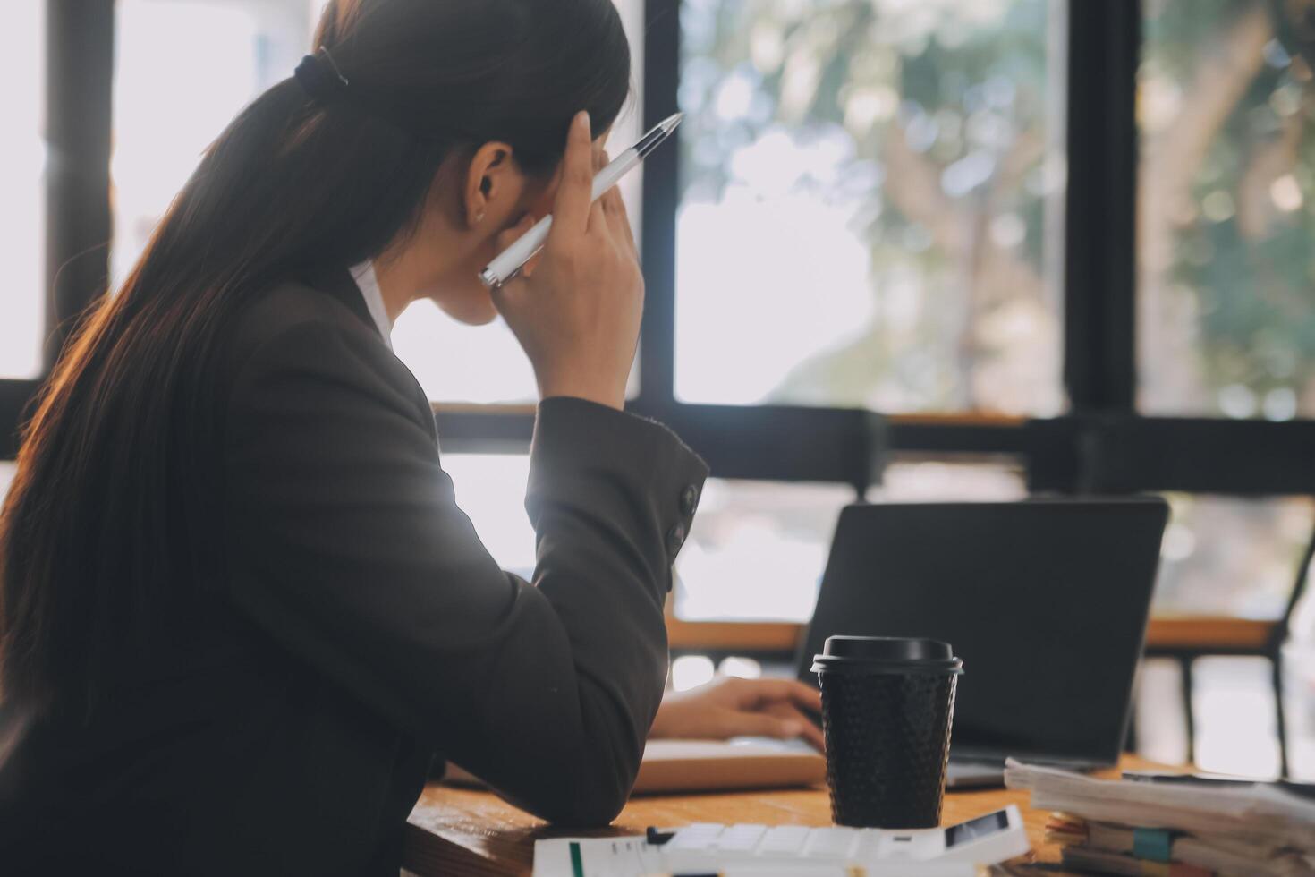 Asian women are stressed while working on laptop, Tired asian businesswoman with headache at office, feeling sick at work, copy space photo