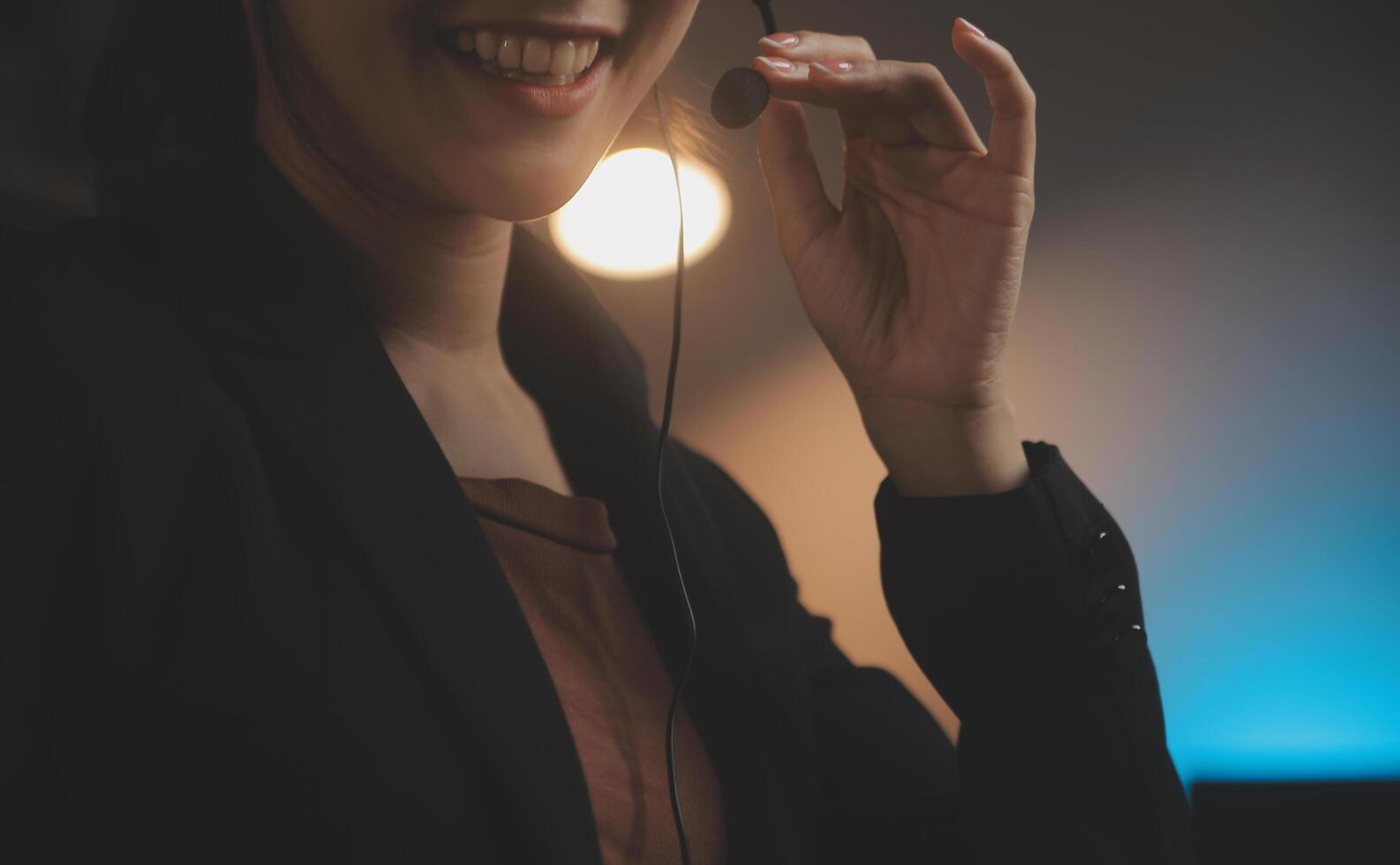 Young woman working in call centre, surrounded by colleagues photo