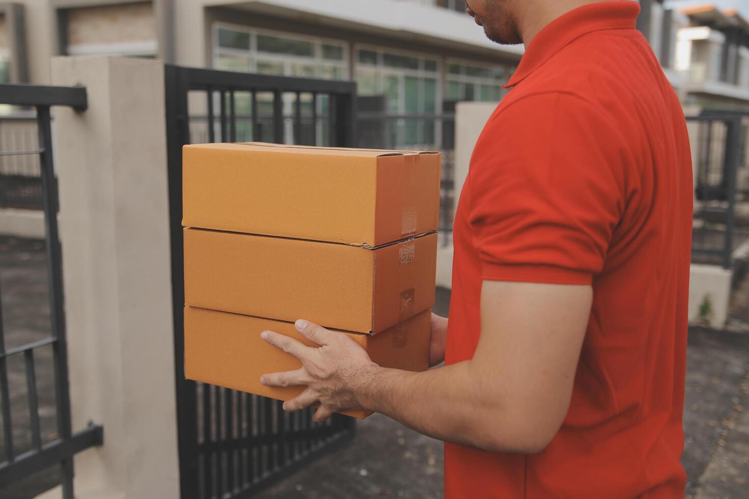 Asian delivery express courier young man use giving boxes to woman customer he wearing protective face mask at front home photo