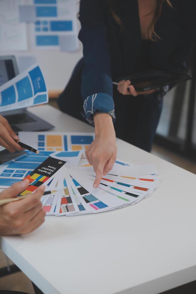 Close up ux developer and ui designer use augmented reality brainstorming about mobile app interface wireframe design on desk at modern office.Creative digital development agency photo