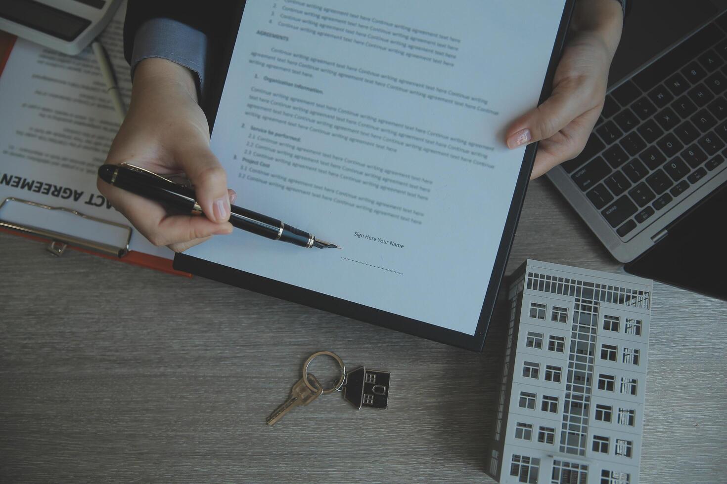 Real estate agent and customer signing contract to buy house, insurance or loan real estate.rent a house,get insurance or loan real estate or property. photo