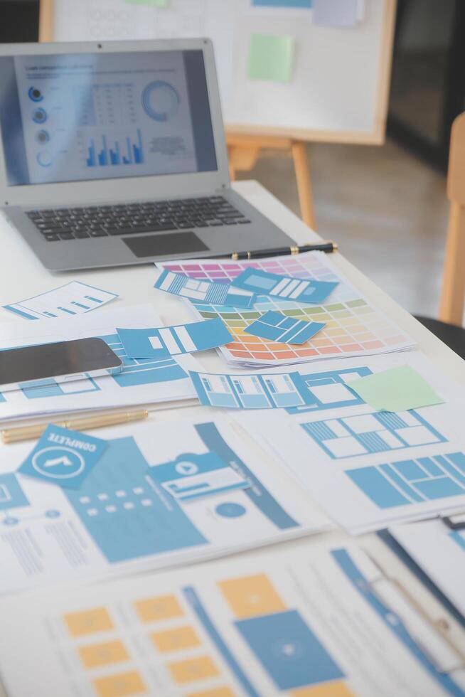 Close up ux developer and ui designer use augmented reality brainstorming about mobile app interface wireframe design on desk at modern office.Creative digital development agency photo