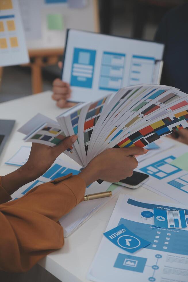 Close up ux developer and ui designer use augmented reality brainstorming about mobile app interface wireframe design on desk at modern office.Creative digital development agency photo