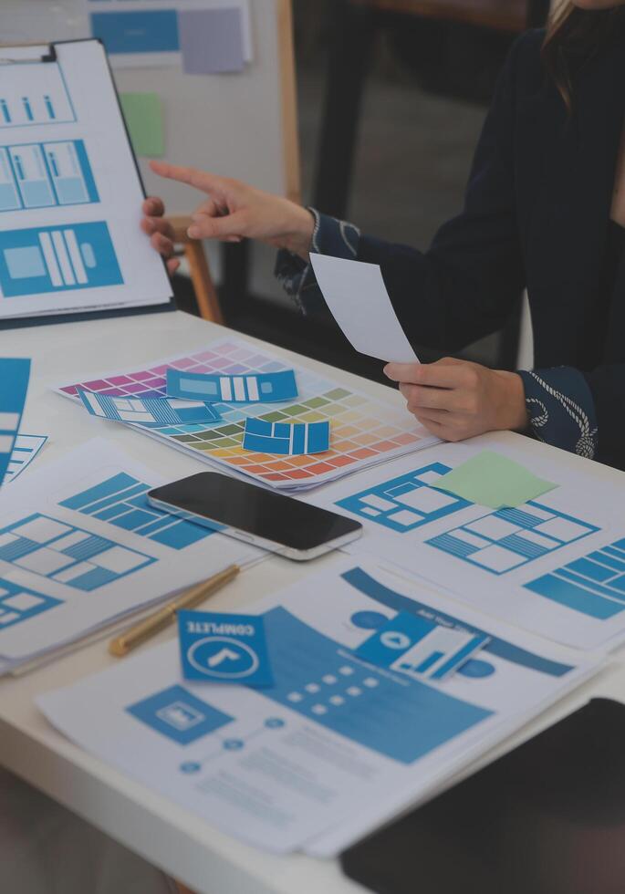 Close up ux developer and ui designer use augmented reality brainstorming about mobile app interface wireframe design on desk at modern office.Creative digital development agency photo