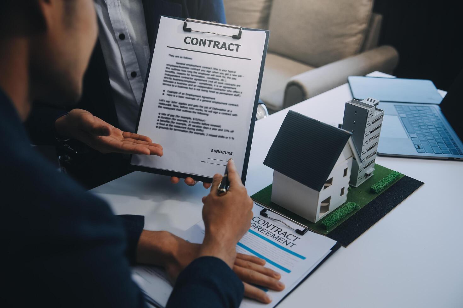 Real estate agent talked about the terms of the home purchase agreement and asked the customer to sign the documents to make the contract legally, Home sales and home insurance concept. photo