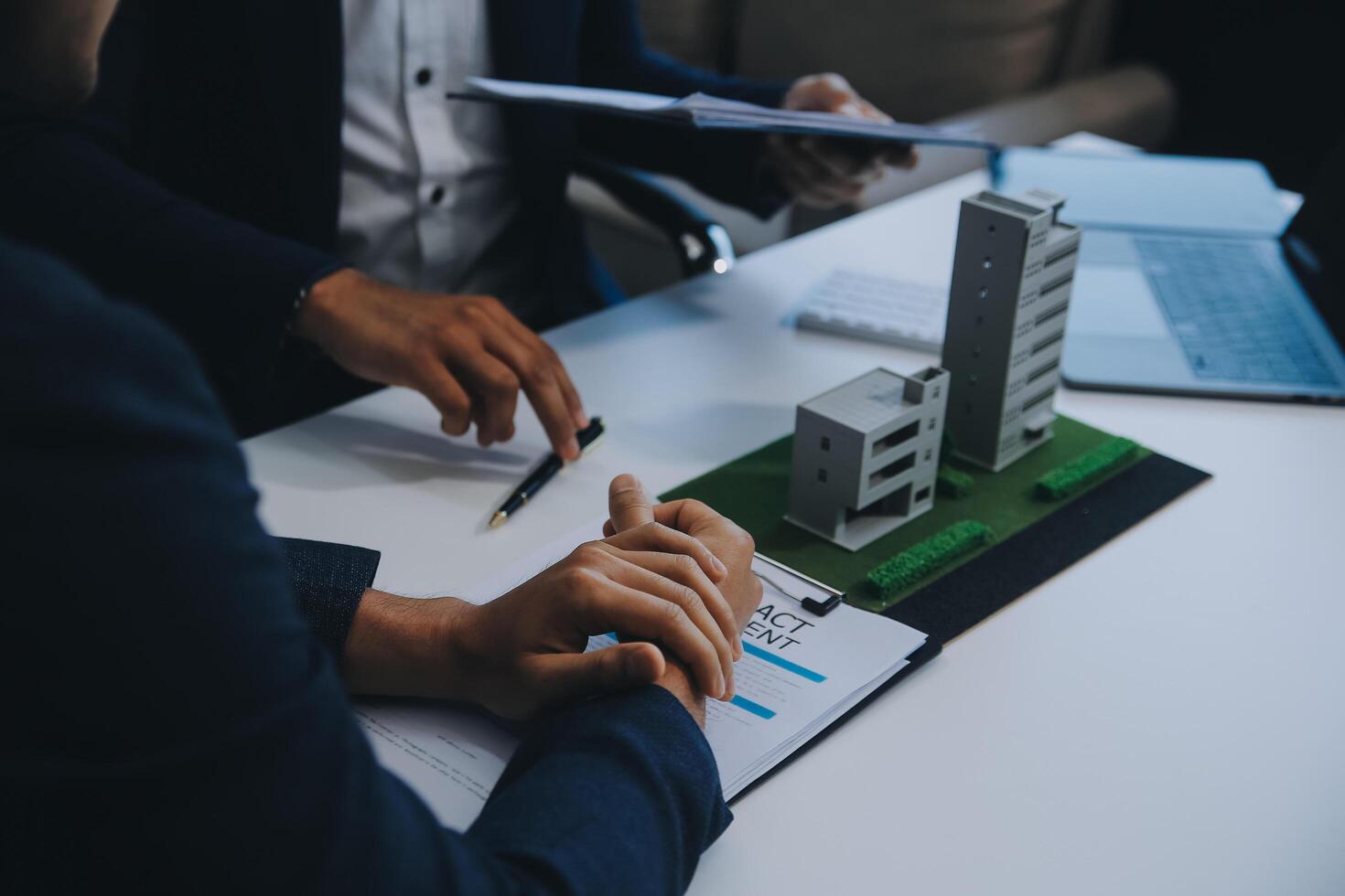 Real estate agent talked about the terms of the home purchase agreement and asked the customer to sign the documents to make the contract legally, Home sales and home insurance concept. photo