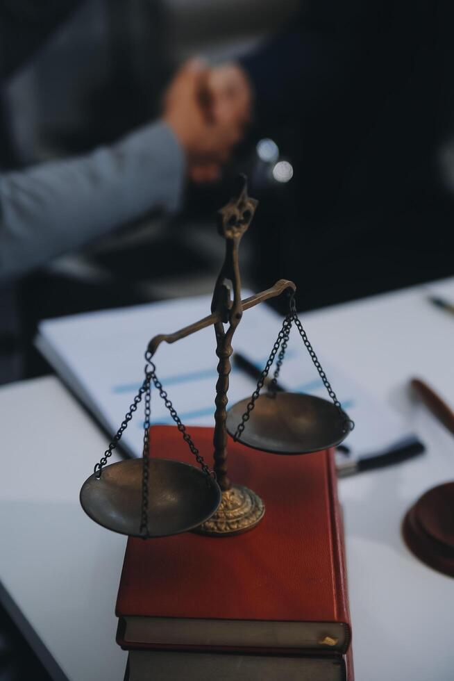 Consultation and conference of Male lawyers and professional businesswoman working and discussion having at law firm in office. Concepts of law, Judge gavel with scales of justice. photo