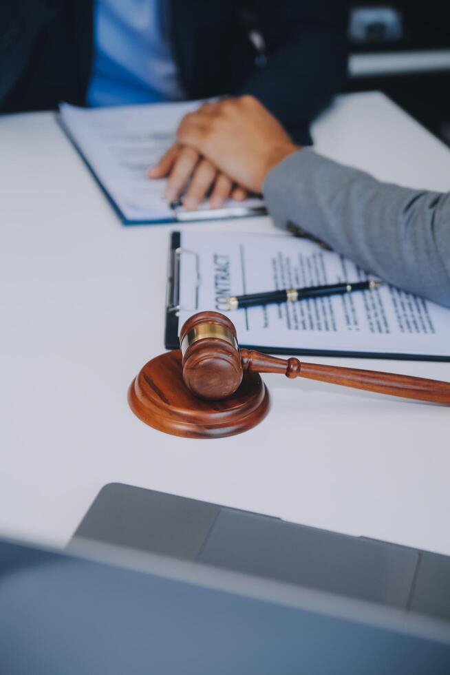 Consultation and conference of Male lawyers and professional businesswoman working and discussion having at law firm in office. Concepts of law, Judge gavel with scales of justice. photo
