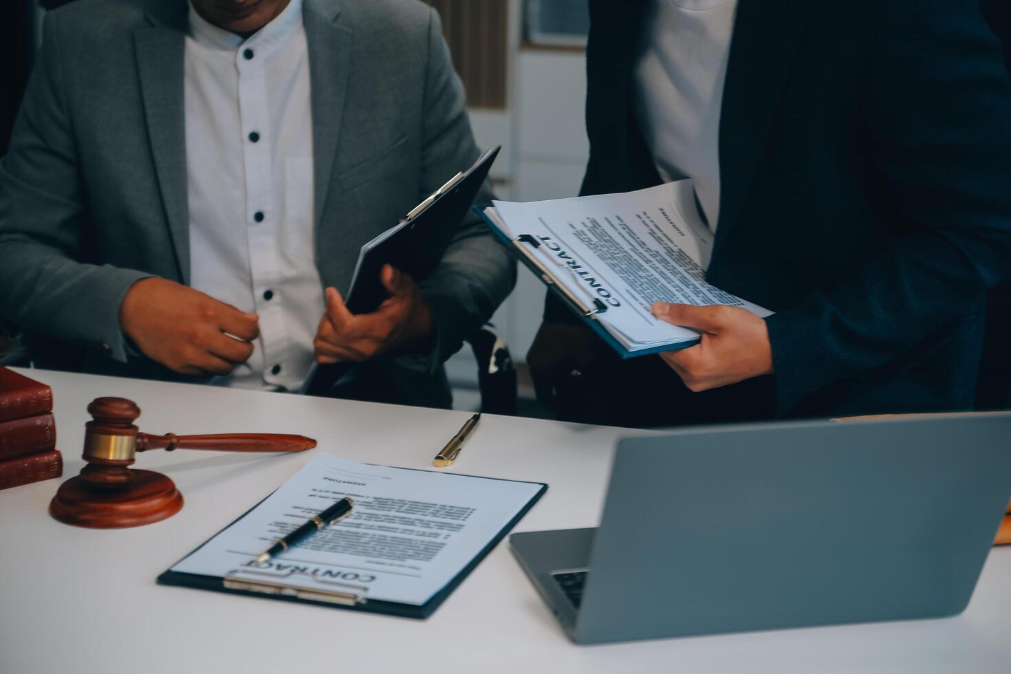 Consultation and conference of Male lawyers and professional businesswoman working and discussion having at law firm in office. Concepts of law, Judge gavel with scales of justice. photo