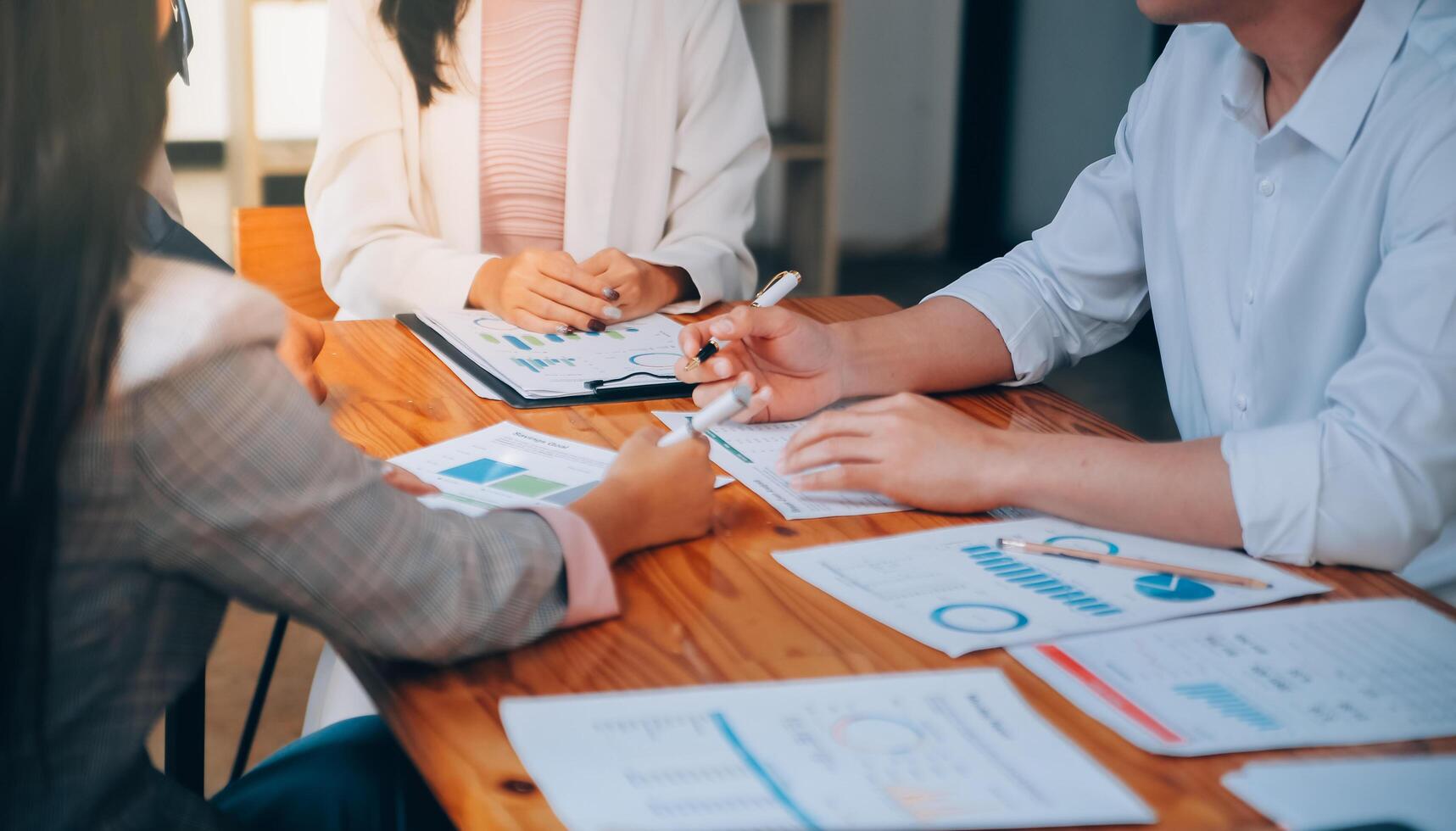 Business team working with new startup project plan and discussion information for financial strategy with laptop and digital tablet in a modern business lounge. photo