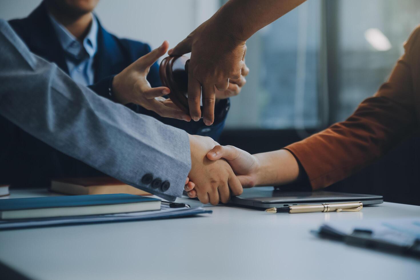 Businessman shaking hands to seal a deal with his partner lawyers or attorneys discussing a contract agreement. photo